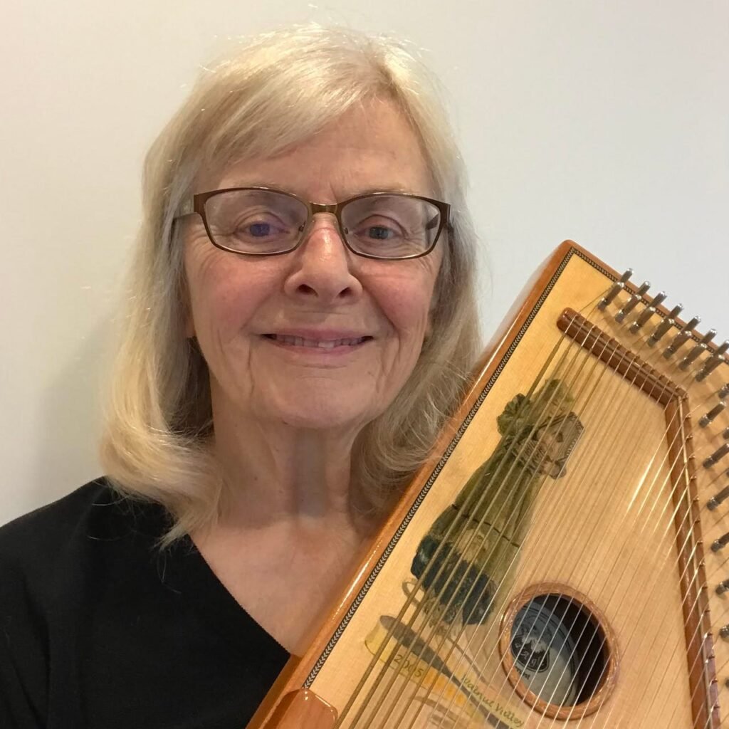 a woman Strumming the Autoharp