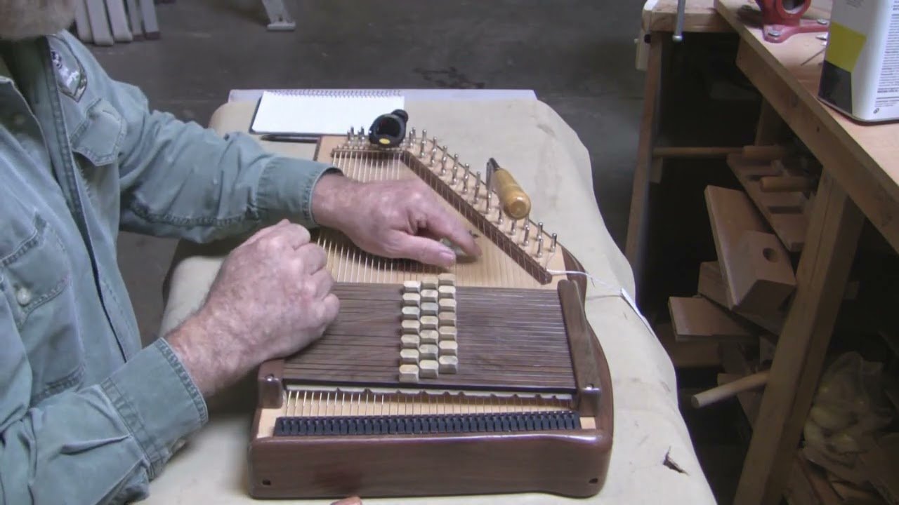 a man tuning his harp