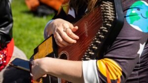 A Man Holding An Autoharp Showing the Best Autoharp Performance Techniques for Beginners